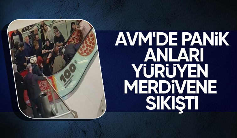 AVM'de yürüyen merdivene sıkıştı