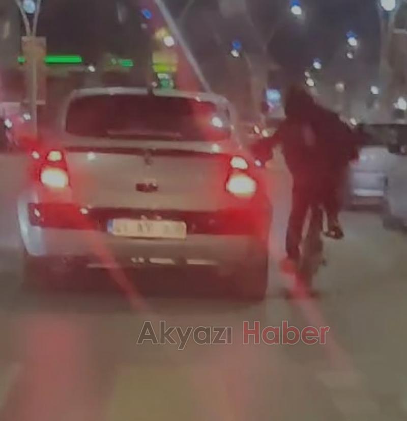 Bisikletli, otomobile tutunup yolculuk yaptı
