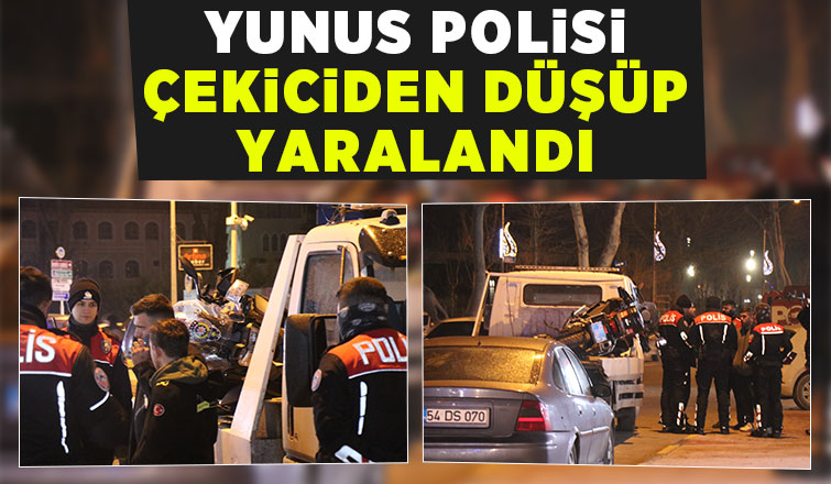 Yan yatan motoru tutmak isteyen polis düşerek yaralandı