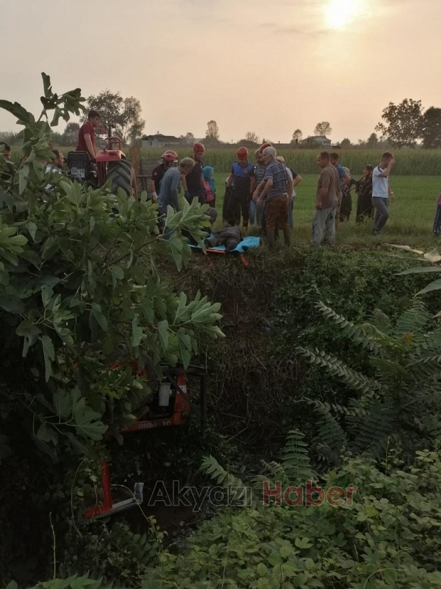 Dereye yuvarlanan traktörün altında kaldı